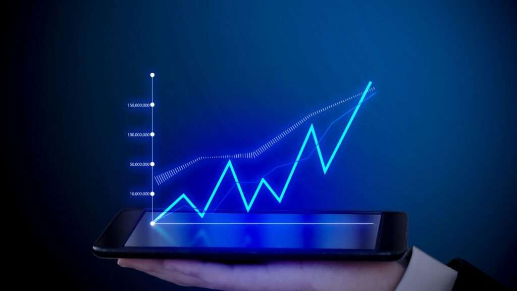 A businessman's hand holds a smartphone displaying increase online sales graph. The image represents the use of SEO services in London.