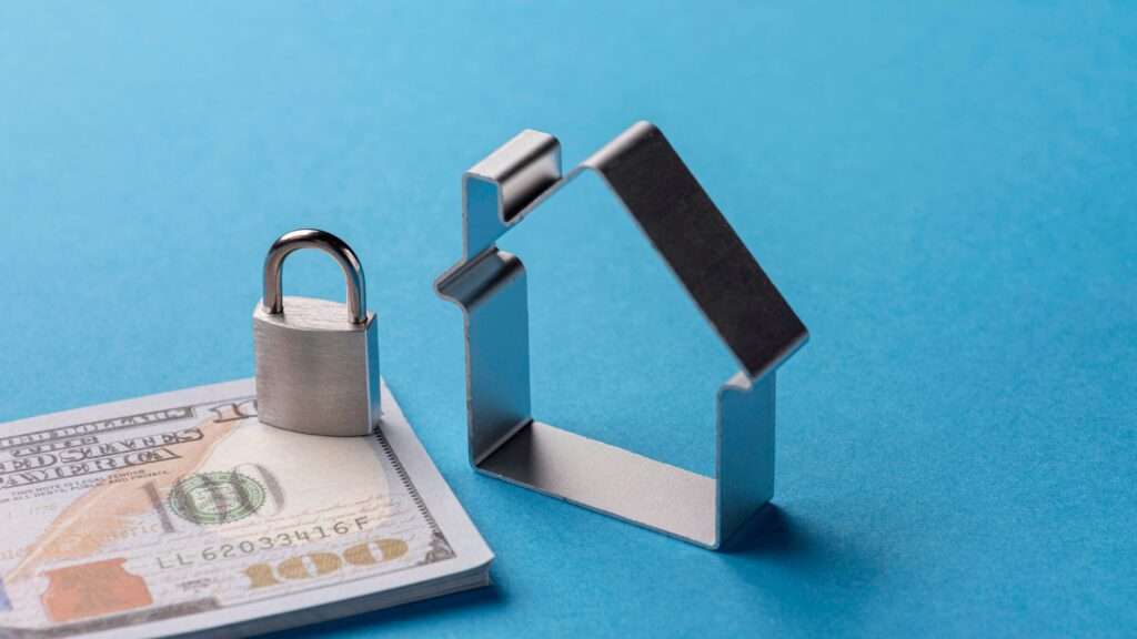 A metal rental property next to a padlock on a stack of money endorsing estate agent oldham